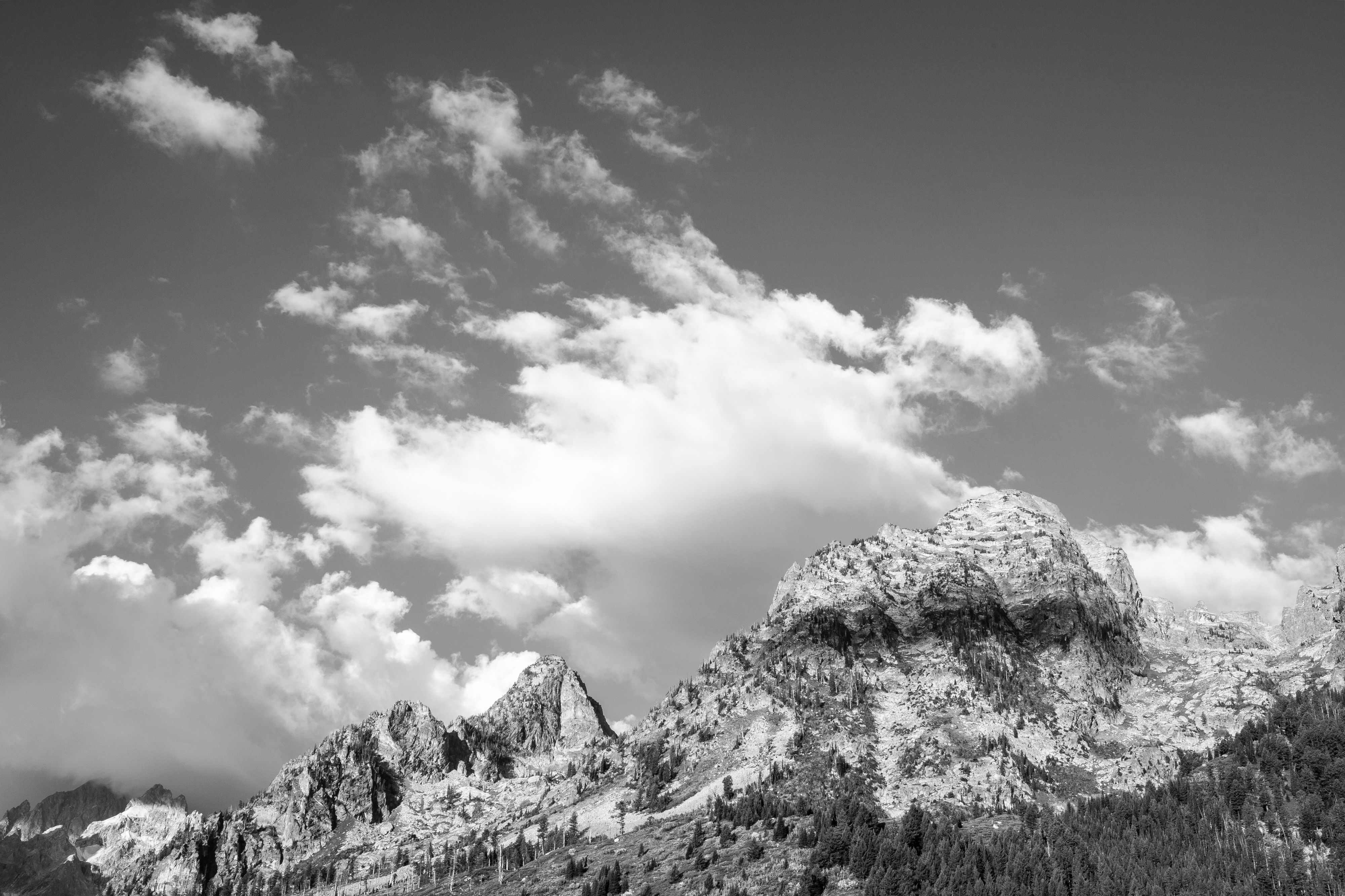 Symmetry Spire and Rockchuck Peak seen under morning clouds from String Lake.